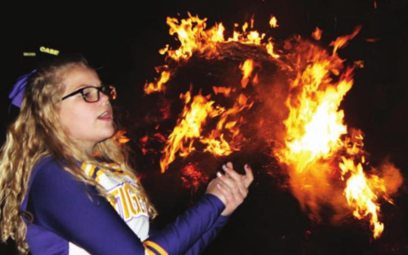 Cheerleader Trinity Leithauser leading cheers at the DHS Homecoming Bonfire that is sponsored by the DHS Booster Club.