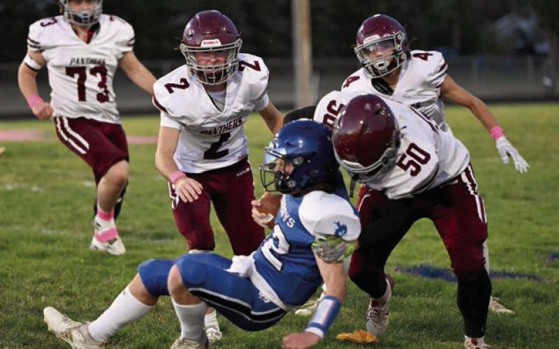 Above, Freshman Broc Bauer (4) goes up in front of a Lemmon-McIntosh defensive back for one of his five catches on the night. Bauer finished with 102 receiving yards and one TD in Timber Lake’s loss 32-8 loss to the Cowboys. At left, senior defensive end Landon Lemburg (50) lays a hit on Lemmon-McIntosh quarterback Nathan Penfield while teammates Cole Ducheneaux (2), Broc Bauer (4) and Braylen Hansen (73) move in to assist. Photos by Marie Du Preez