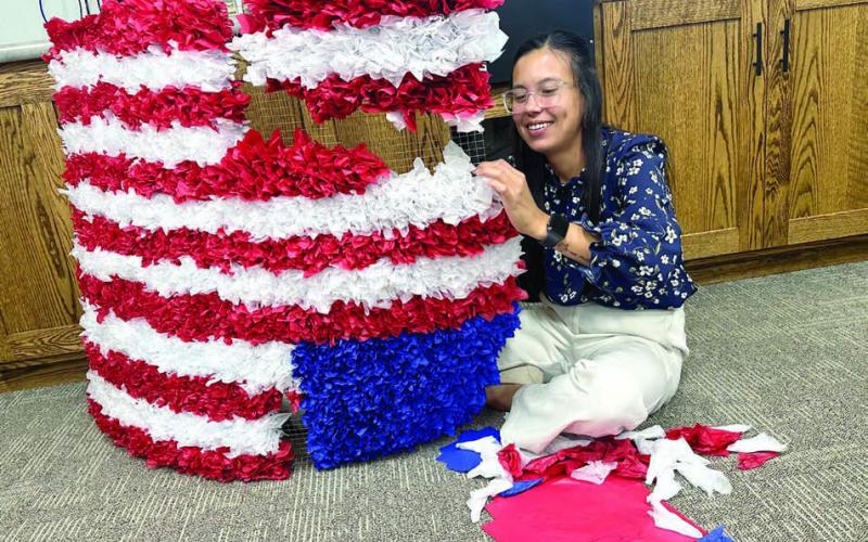 Sierra Eagleman stuffs tissue paper in a screen for Western Dakota Bank’s float which will appear in the Timber Lake and Isabel parades the next two Saturdays. See details about both celebrations inside this issue. Photo by Kathy Nelson