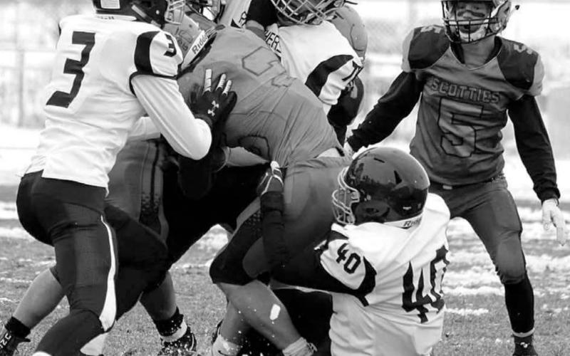 Panther defenders Chazz Gabe (3) Patrick Marshall (77) and Jaiden Ducheneaux (40) gang up on a Philip ball carrier during their 9-man playoff football game last week. Photo by Chelsea Tobin, Philip Pioneer Review