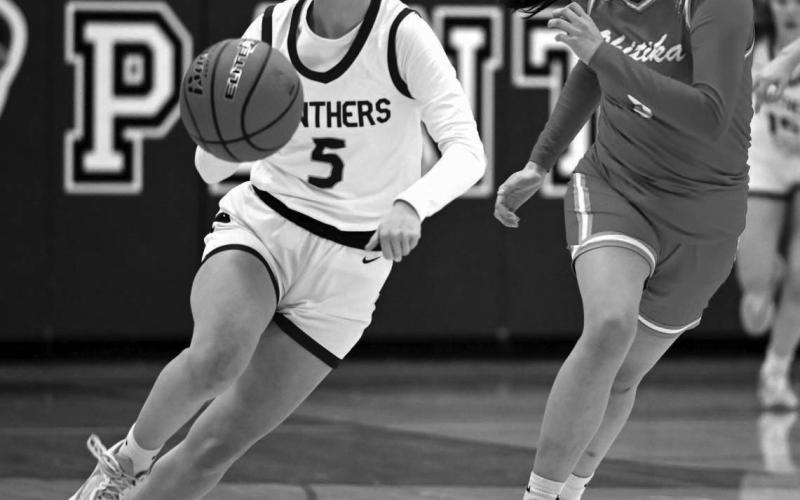 Panther senior Averie Marshall pushes the ball up-court during recent action against an unidentified Cheyenne-Eagle Butte defender during recent action. The Lady Panthers won the battle for bragging rights in Dewey County 52-37. Photo by Marie Du Preez