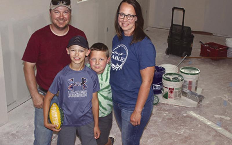 Chance and Merretta Anderson, shown with sons Gus and Hank, have purchased the former Masonic Lodge in Isabel and are currently remodeling the building to become the new home of Red Earth Table, an expansion of their already successful home-based bakery. They plan to open the bakery and breakfast diner this fall. Photo by Jon Flatland