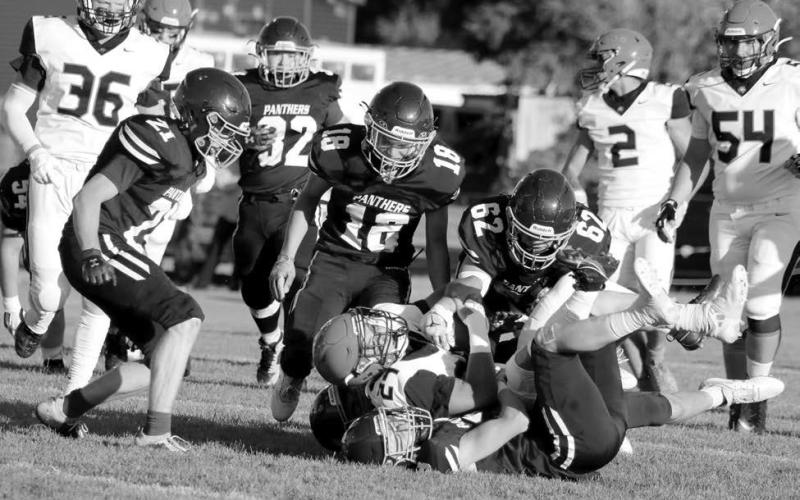 Timber Lake linebacker Cole Ducheneaux (on the bottom of the pile) gets an assist in tackling a Philip runner from Treyton Du Preez (62) as Brody Ellison (18) and Eddie Keller (21) move in and Gabe Keller (32) trails the play. The Panthers will attempt to break out of two-game losing streak when they host North Central on Friday, Sept. 6, in a 6 pm kickoff at Kraft Field. Photo by Jon Flatland