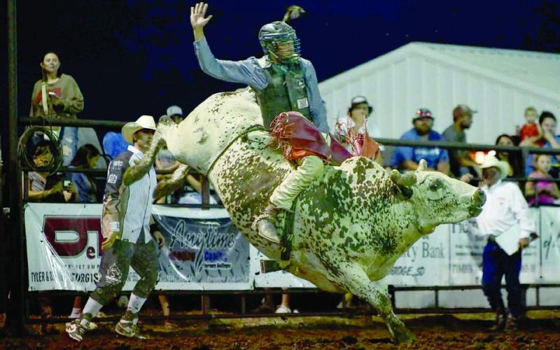 Left, Chazz Gabe of Timber Lake scored 82 points to win the bull riding event at the Herreid Rodeo last weekend. Gabe currenly leads the South Dakota Rodeo Association standings. Photo by Chuck Miner