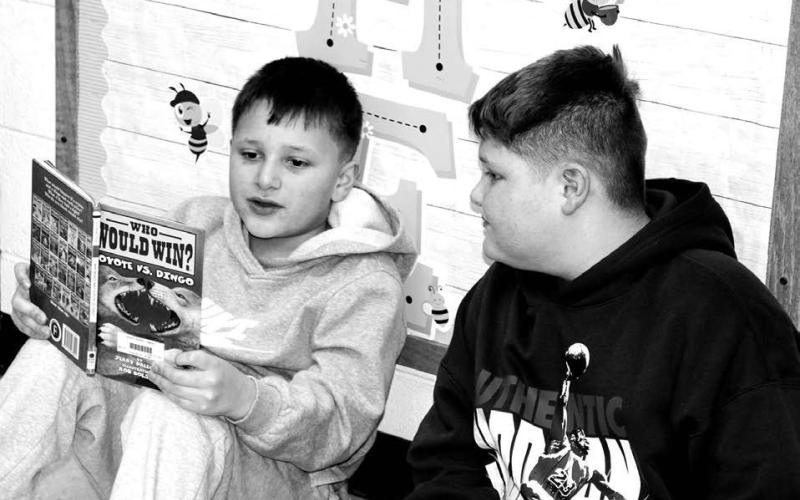 Ryatt Wright (3rd grader) reading to Jett Keckler (6th grader)