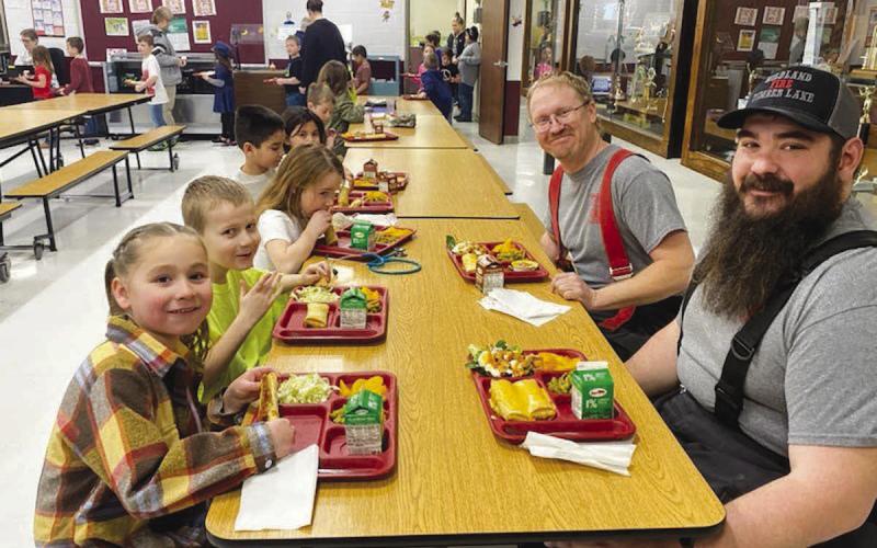 Timber Lake Elementary School honored firefighters, EMTs and others at Community Heroes Day on Tuesday, March 21. Brent Gill and Shad Bollinger (RIGHT) had lunch with Josie Fiddler and Quayde Gill (LEFT). Photos by Alision Nilson