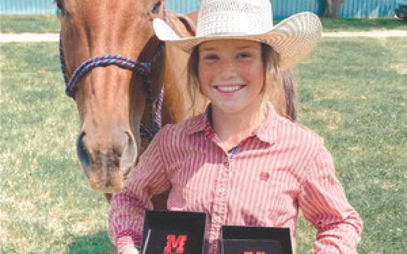 Korbi Heck of Isabel and her horse, Jetta, won both the Junior Girls Barrel Racing and Junior Girls Pole Bending championships on Saturday, July 8, at the Harding County 4-H Rodeo in Buffalo. Heck is one of several area competitors to garner gold buckles at the event.