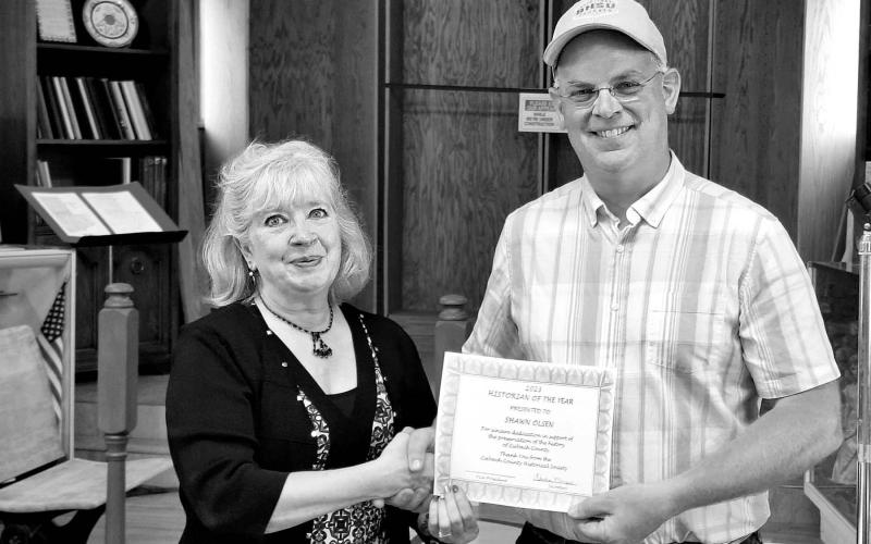 LEFT: Kim Shannon (left) presents Shawn Olsen with the Historian of the Year award.