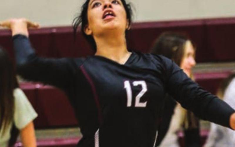 Kessa Bigger gets ready to send a serve over the net.