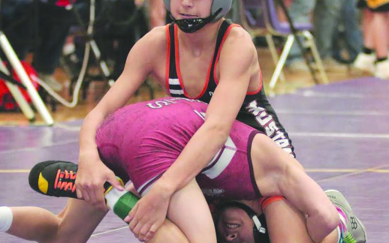 Ethan Ward (top) of McLaughlin-Timber Lake has Logan Pankratz of Marion-Freeman wrapped up in a tight little package during their match in the first-round of the 106-pound division at the Big Dakota Conference Wrestling Tournament in Ft. Pierre on Saturday, Feb. 4. Pankratz was able to turn the tables on Ward and pulled out a 6-4 decision for the win. Photo by Jon Flatland