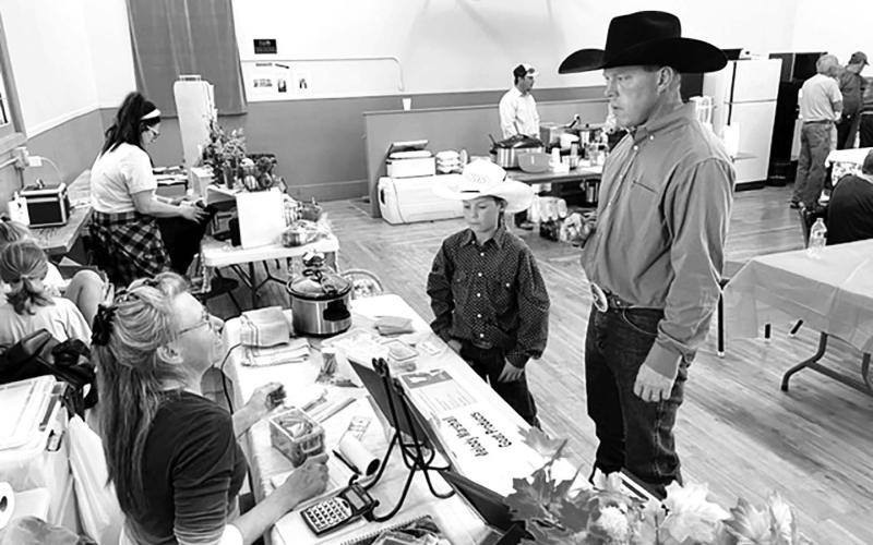 Melody Marshall of rural Timber Lake (LEFT) talks about her goat meat products with Justin Thompson and son of rural Mobridge. Photos by Kathy Nelson