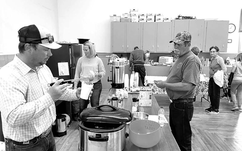Chance and Merretta Anderson of Isabel served up beef stew, chili and other tasty foods at the Trail City Fall Festival on October 2. At right is Mike Buechler of McLaughlin.