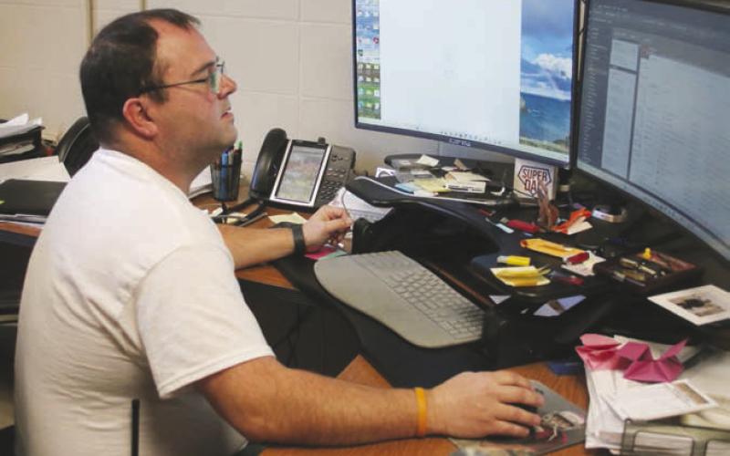 Timber Lake School IT Director Joel Schweitzer looks over plans for the $120,000 replacement of internet components aimed at keeping the district up-to-speed on the information superhighway. Photo by Jon Flatland