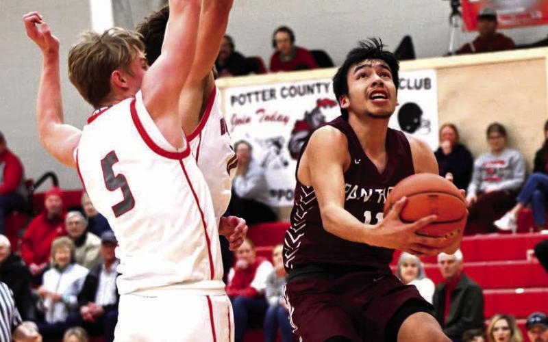 Timber Lake guard Tristan Dupris drives to the hoop for a scoop layup and two of his 18 points in the Panthers’ 62-51 loss to Potter County last Friday, Feb. 23, in the final regular season game for both teams as region tournaments tipped off Tuesday. Photo by Marie Du Preez