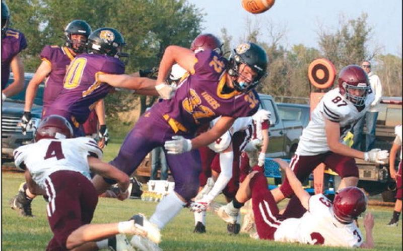 Dupree running back Braydon Terveen-Smith coughs up the football after taking a hard shot from Timber Lake defender Gracen Hansen (4) during the second quarter of the Tigers’ 26-6 upset over the Panthers last Friday, Sept. 9. Terveen-Smith was Dupree’s plow horse, finishing the contest with 110 yards and three TDs on 27 rushing attempts. Photos by Jon Flatland