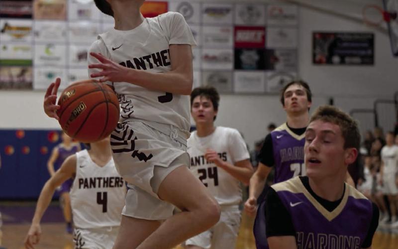 Panther guard Braden Lawrence loses his grip on the basketball while driving to the hoop on a layup attempt during Timber Lake’s win over Harding County in the LMC Tournament. Defending on the play is Shawn Glines of Harding County. Photo by Marie DuPreez