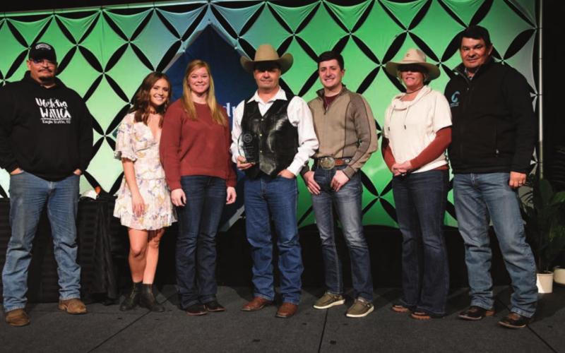 Zach Ducheneaux (CENTER) and the team at DX Ranch were recently honored as finalists for the 2021 Top Producer of the Year award at Farm Journal’s Top Producer Summit in Nashville. L-R are Bud Ducheneaux, Calico Ducheneaux, Melissa Loeschen, Zachary Ducheneaux, Ty Ducheneaux, Tausha Kraft-Ducheneaux, and Guthrie Ducheneaux. Not pictured: Kelsey Ducheneaux, Monte Scott, Burt Dillabaugh, and the rest of the family and friends back home on CRST. Photo by Chuck Zimmerman, Top Producer