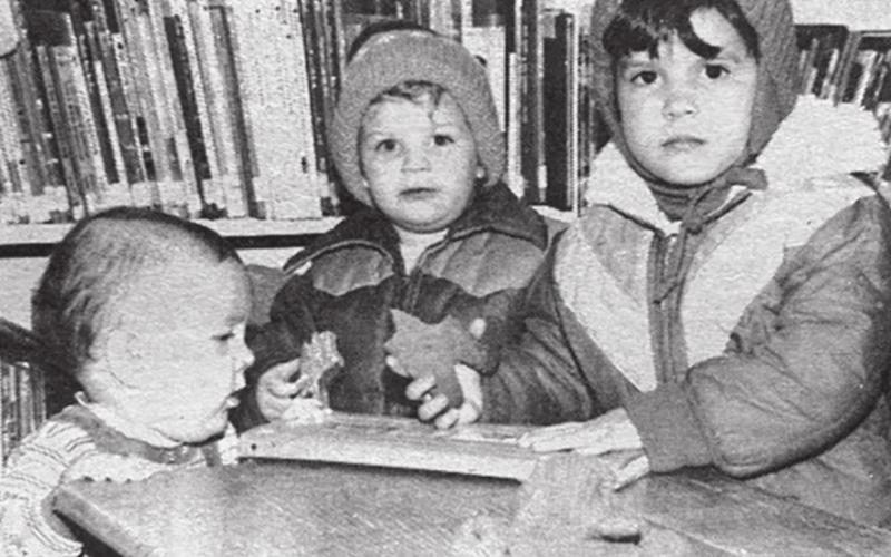 At the library Cassie, Beaman and Chasity Kraft munch on gingerbread men after the Christmas movies at the library Saturday. About 20 children and mothers attended the showing. Cassie and Chasity are the daughters of Mike and Donna Kraft. Beaman is the son of Dave and Mary Lou Kraft. Timber Lake Topic, December 24,1981