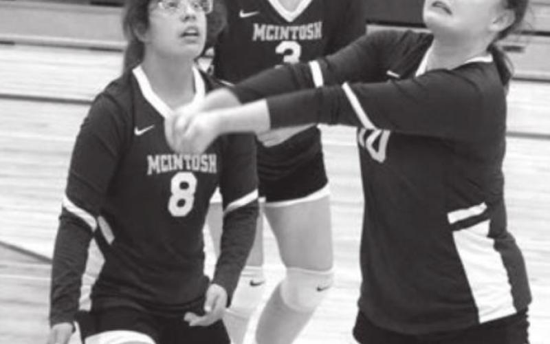 LEFT: McIntosh’s Irian Mittleider returns a serve back over to the Timber Lake side.