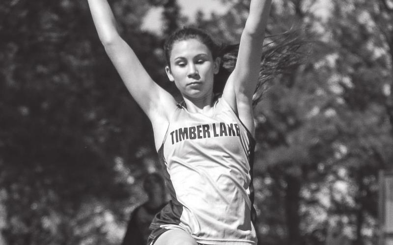 Natalie Lawrence takes flight in the long jump.