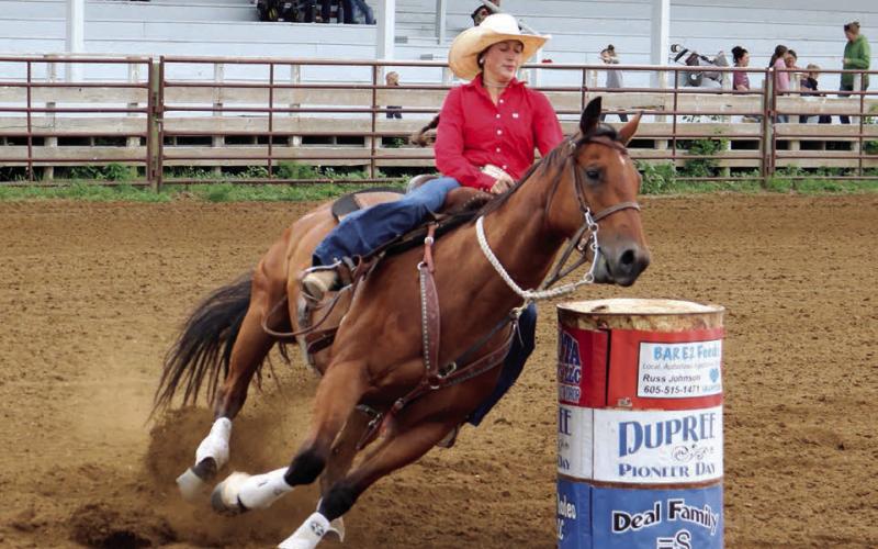 Jazmyn Longbrake of Dupree leans in as her horse makes the final turn during barrel racing action Saturday, July 19, at the 4-H regional rodeo in Dupree. No results were posted by the time this issue of the Topic went to press. Photo by Jon Flatland