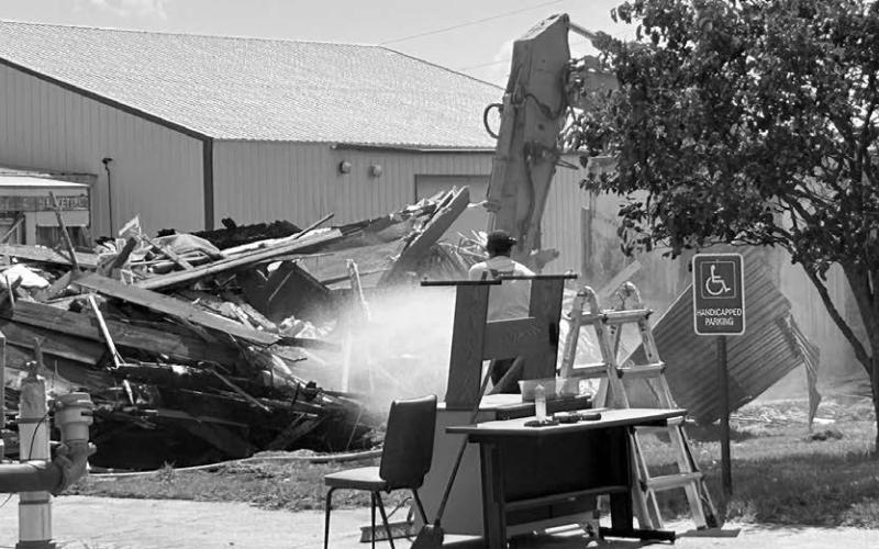 A building that had housed several businesses on Isabel’s Main Street, including a candle shop, was demolished on July 1.