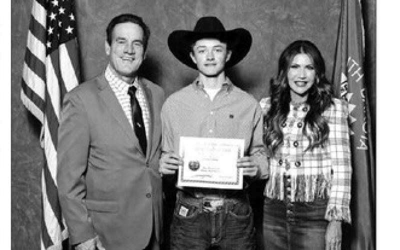 Treg Thorstenson of Dupree was honored as the top senior from the DHS Class of 2023. He is pictured with Lt. Gov. Larry Rhoden (LEFT) and Gov. Kristi Noem.