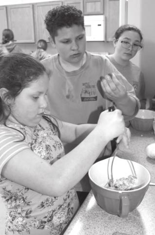 “The Shmarties” work together to mash an avocado and prep their spinach and green bean pesto. (L-R): Gabby DeLaRosa, Wyatt Lemke, and Sierra Feickert.