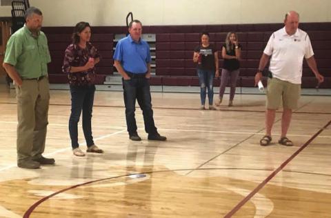 Timber Lake School officials admire the re-designed look of the new wood floor in one of the school's gymnasiums last Wednesday as part of a walking tour through the building to see the progress being made on a variety of improvement projects. L-R are board members Jake Kraft, Rae O'Leary, Bryce Lindskov and Marie Gross; business manager Amanda Hermes and Supt. Dan Martin.