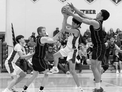 Panther guard Pete Maher splits a pair of Faith defenders on his way to the hoop during Timber Lake’s 59-- 42 win over the Longhorns last Thursday, Jan. 8. Looking on is Jackson Bigger (left). The Panthers are 5-2 overall heading into this week’s schedule. Topic Photo/Marie DuPreez