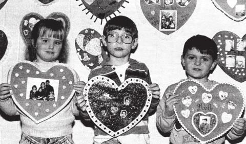 Sweethearts Timber Lake Topic, February 13, 1992 Kindergartners Jackie Kuhn, Jace Hieb, and Jason Booth show the valentines they made at home with their families. Teacher Rita Long made each student a red heart with the family’s last name on it, and the decorating was done at home. The valentines are on display in the hallway at Timber Lake Elementary School.