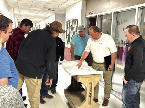 Representatives from Johnson Controls Inc. go over building blueprints with members of the Timber Lake School Board last Wednesday, March 13, during a tour of the school building and overview of heating and cooling improvements being made as part of a more than $1 million HVAC upgrade. Pictured l-r are TLHS Technology Coordinator Joel Schweitzer, board member Tyrone Kraft, board president Jake Kraft, Project Manager Terry Holland of Johnson Controls Inc,, project supervisor John Paul of Johnson Controls Inc