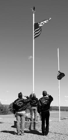 The Color Guard from Smith-Wright American Legion Post 120 in Isabel salutes the flag after raising at from half-mast during a Memorial Day program at Hillview Cemetery near Isabel. After the American flag was raised, the POW/MIA flag and those of each branch of the U.S. military were raised as well. Photo by Jon Flatland