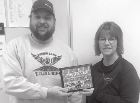 Ryan Gimbel receives the Teacher of the Year Award from Julie Marshall, MS/HS Principal. He will be nominated for the Regional TOY award.