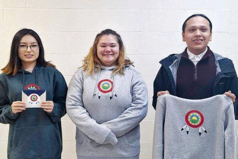Dupree students who participated in the CRST Farm to School logo contest included (l-r): Jamie Black Moon (who won second place), Izzy Jeffries, and Wambli Quintana. They are displaying the winning logo, which was created by Alicia Condon, a student at Takini School. Photo by Patty Peacock