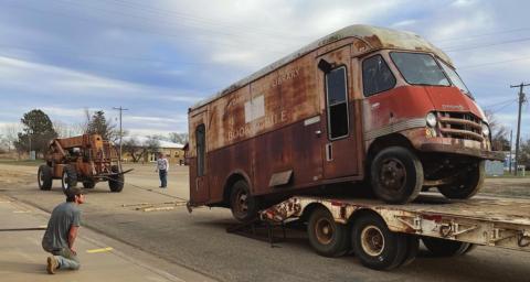 Michael Frank (FRONT) transported the bookmobile from Isabel to Timber Lake, where Marty and Scott Biegler and crew unloaded it. Troy Lindskov recently bought the vacant lot where it was sitting. He and his dad, Corey, helped load it onto Frank’s flatbed trailer. Photos by Kathy Nelson
