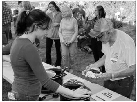 Norman Hieb (RIGHT) was invited to start the line at the meal served at the Timber Lake School Healing Hands (Owaste Napiceya) Garden on September 19. Lola Hornick (LEFT) was one of the servers. Dishes prepared from the garden’s produce were served, along with burgers from beef donated by Lindskov LT Ranch, Schrempp Cattle Co., Maher Ranch, and Hornick Ranch.