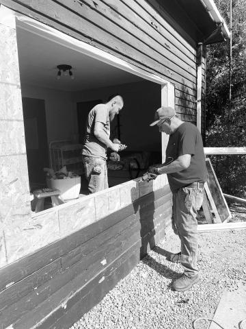 Joel Mattern (RIGHT), owner of J&amp;J Construction of Lemmon and a member of the McIntosh Class of 1972, and one of his employees, Joey Heidecker, install new windows in the McIntosh Daycare.