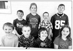 AT RIGHT: 3rd and 4th grade FRONT (L-R): Third graders Ben Mareska and Camden Goldade (winners) and Colton Ridl and Baicyn Lei (alternates). BACK: Fourth graders Barrett Maciejewski and Brynn Lemburg (winners) and Greyson Goldade and Brayden Meier (alternates).