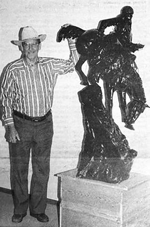 Col. Maynard Booth with the Frederic Remington sculpture he donated to the Timber Lake Museum