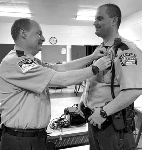 Retiring Corson County Sheriff Keith Gall (LEFT) pins the sheriff’s badge on his former deputy, Alan Dale, who was appointed sheriff effective March 13.