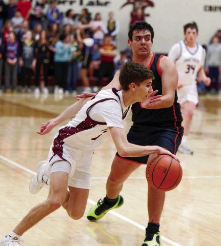 Timber Lake guard Braden Lawrence dribbles past a would-be Faith defender during the Panthers 59-43 conference win over the Longhorns last Thursday, Jan. 8 in Timber Lake. Lawrence finished the contest with eight points and a half-dozen assists. Topic photo by Marie DuPreez