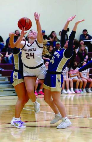 Panther freshman Maddy Hermes (24) draws a foul while driving to the basket between two Sully Buttes defenders. Timber Lake rallied in the fourth quarter to down the Chargers 57-49. Topic Photo/Marie DuPreez