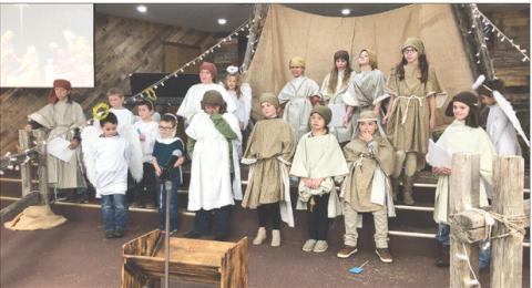 The children of New Hope Church at Timber Lake presented a Christmas program during the worship service on Sunday, December 11. Participants were FRONT (L-R): D.W. Schultz, Waylon Maher, Ridge Means-Takes The Knife, Alexa Roggow, Leah Eigelaar, Luhan Fourie, Louis Scholtz; BACK: Max Goldade, T.K. Paxton, Tash Paxton, Ronnilyn Long, Dolly Goldade, Naomi Goldade, CeCe Cowan, Brynn Lemburg, Bricelyn Pederson, Nika Fourie. Photo by Pastor Bryce Schaffer