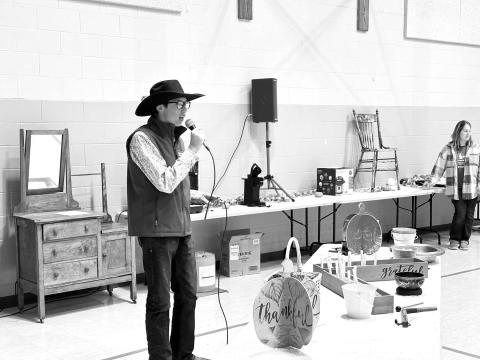 Kade Conner was the auctioneer for the live auction at the Prairie Parish Fall Festival on Sunday, November 5 at Timber Lake. The event also included a ham and turkey dinner with all the trimmings, a bake sale and a silent auction. Prairie Parish is made up of the United Parish of Timber Lake and the UCC at Isabel. Photo by Kathy Nelson
