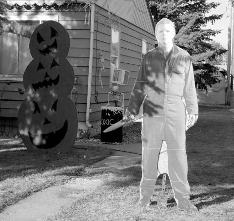 There’s not a crazy man with a knife loose in Timber Lake ... that’s just a cardboard cutout of Jason from the Halloween horror movie series hanging out in the front yard of Bruce Schweitzer along with some scary pumpkins, a toxic waste barrel and more. Photo by Jon Flatland