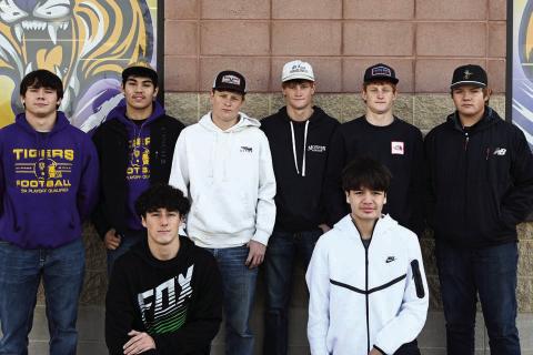 The 2025 Little Moreau Conference champion Dupree Tigers, above, had eight players selected to receive all-conference football honors. Pictured are front row (l-r) Traden Meeks and Ricco Swallow, both honorable mention selections, and in the back row (l-r) are all-conference honorees Michael Donovan, Braxton Schad, Tee Birkeland, Cruz Birkeland, Fletcher Birkeland and Tanner Thorstenson. Above right, seniors Tayshaun Cudmore and Spencer Olsen (l-r) were Class A Cross Country All-State selections for posting