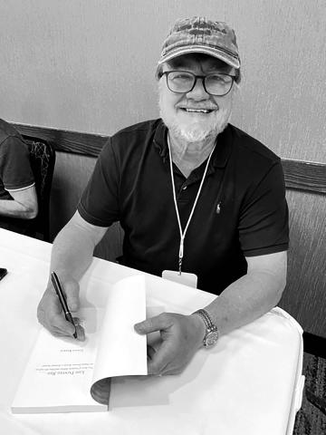 Author Chuck Raasch autographs copies of his book at the South Dakota Festival of Books in Deadwood in September. Photo by Karen Holzer