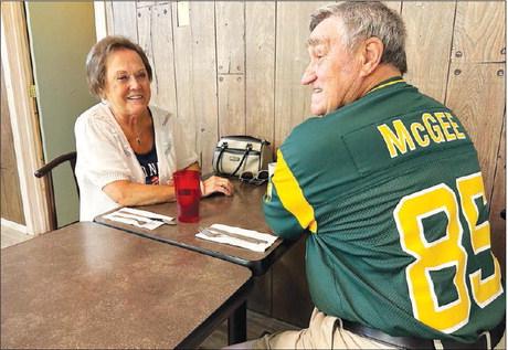 Jim Rolfes, part-owner of the Green Bay Packers, sports his Green Bay #85 Max McGee jersey while having breakfast with his wife, LuElla (Meyer) at Timber Lake during the Days of 1910.