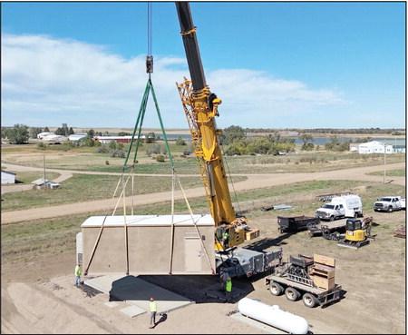 A crane was brought in last Wednesday, Sept. 18, to drop the new central office of the CRST Telephone Authority rural broadband expansion project into place on the east edge of Timber Lake near the rodeo grounds. Topic photo by Roger Lawien
